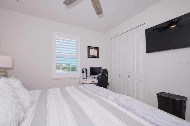 bedroom featuring ceiling fan and a closet