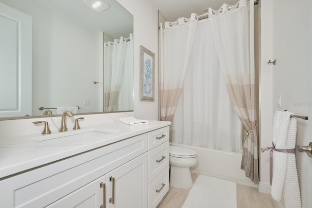 full bathroom with toilet, wood-type flooring, vanity, and shower / tub combo with curtain