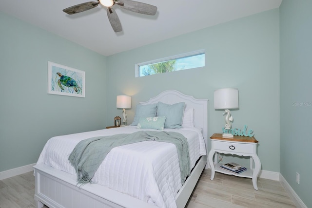 bedroom with ceiling fan and light hardwood / wood-style floors