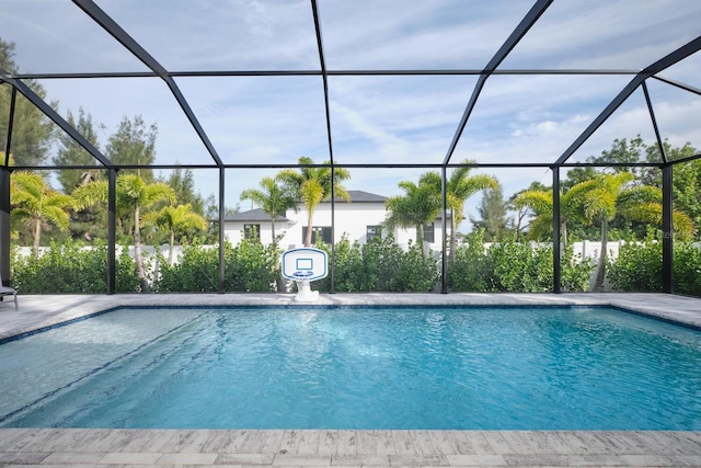 view of swimming pool featuring a lanai