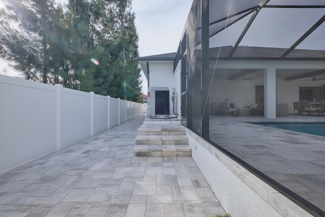 view of patio / terrace featuring a fenced in pool, ceiling fan, and a lanai