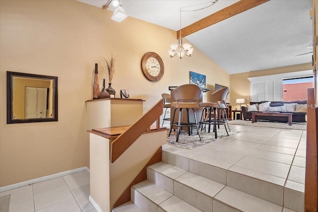 staircase featuring tile patterned floors, vaulted ceiling with beams, and an inviting chandelier