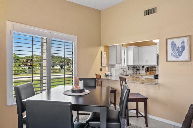 dining area with sink and light tile patterned floors