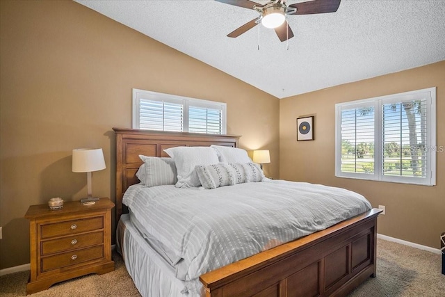 bedroom featuring ceiling fan, lofted ceiling, carpet floors, and a textured ceiling