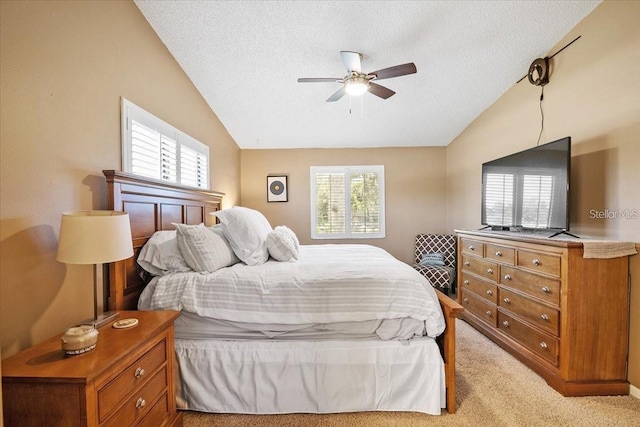 carpeted bedroom with multiple windows, ceiling fan, and lofted ceiling