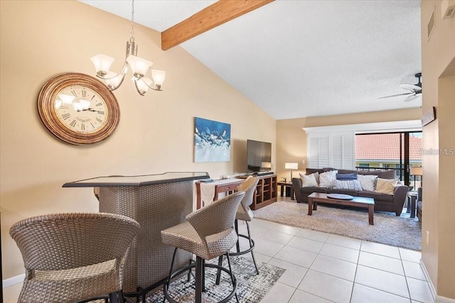 tiled dining area featuring ceiling fan with notable chandelier, a textured ceiling, and vaulted ceiling with beams