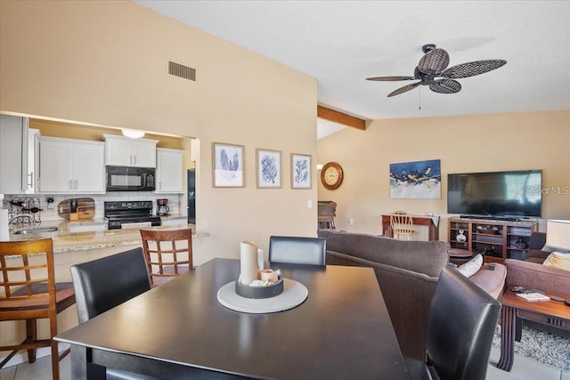 dining space with lofted ceiling with beams, sink, and ceiling fan