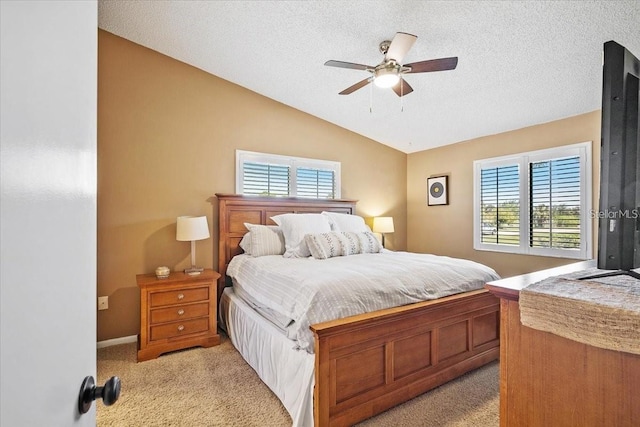 carpeted bedroom featuring ceiling fan and lofted ceiling