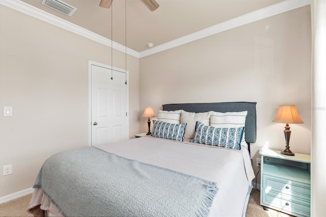 carpeted bedroom with ceiling fan and crown molding