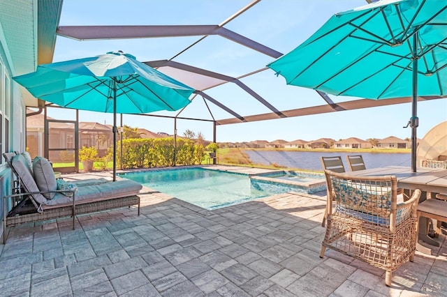 view of pool with a lanai, a patio area, and an in ground hot tub