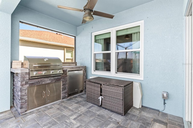 view of patio with area for grilling, a grill, and ceiling fan