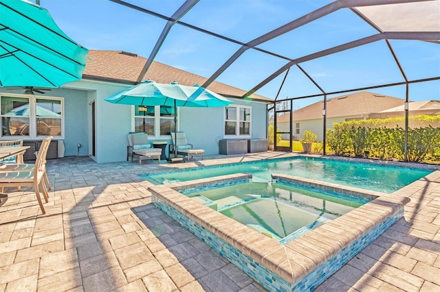 view of pool featuring an in ground hot tub, a patio, and glass enclosure