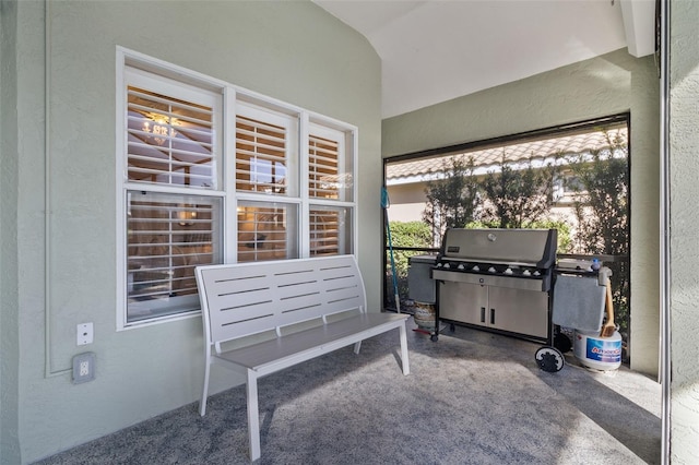 sunroom featuring lofted ceiling