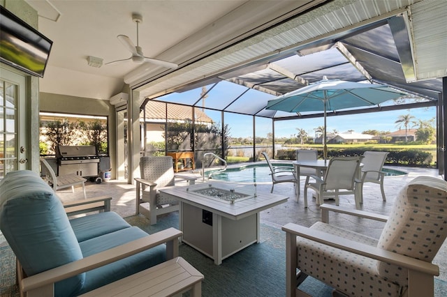 view of patio / terrace with glass enclosure, a grill, ceiling fan, and an outdoor living space with a fire pit