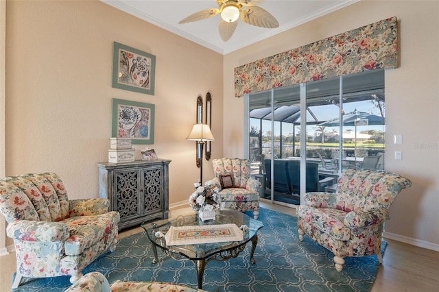 living area featuring wood-type flooring, ceiling fan, and ornamental molding