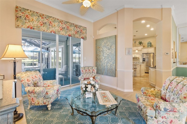 living room with ceiling fan, ornamental molding, and light hardwood / wood-style flooring