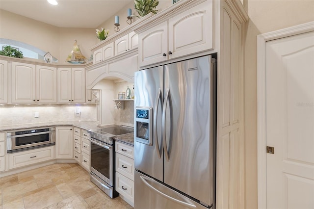 kitchen featuring backsplash, stainless steel appliances, and stone countertops