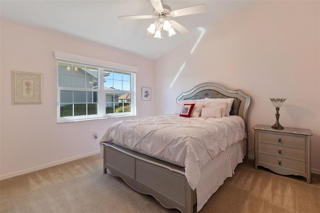 bedroom featuring ceiling fan, light colored carpet, and lofted ceiling