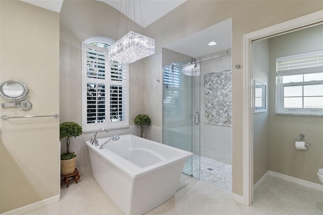 bathroom featuring toilet, tile patterned floors, separate shower and tub, and a notable chandelier