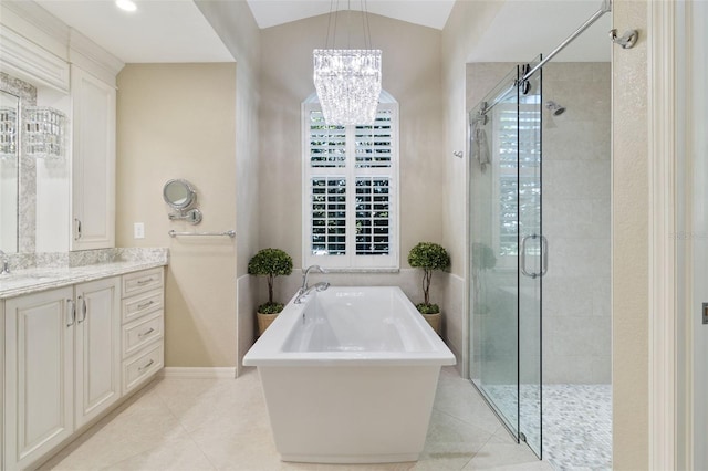 bathroom with tile patterned flooring, shower with separate bathtub, lofted ceiling, and vanity