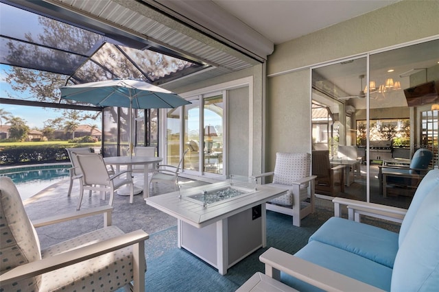 view of patio / terrace with an outdoor living space with a fire pit and glass enclosure