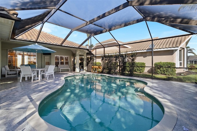 view of swimming pool with a lanai and a patio area