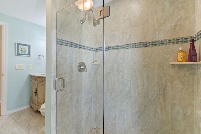 bathroom featuring vanity, an enclosed shower, and toilet