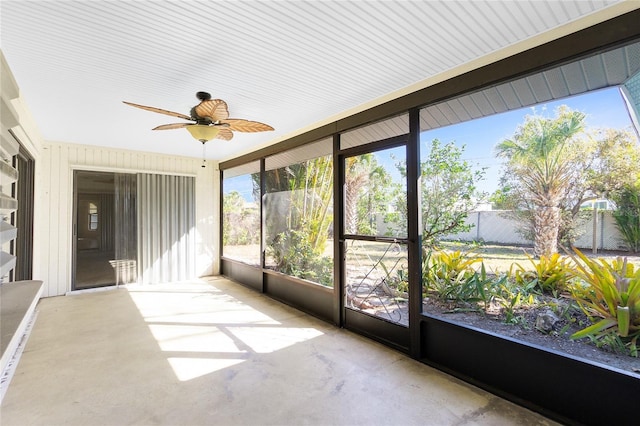 unfurnished sunroom with ceiling fan