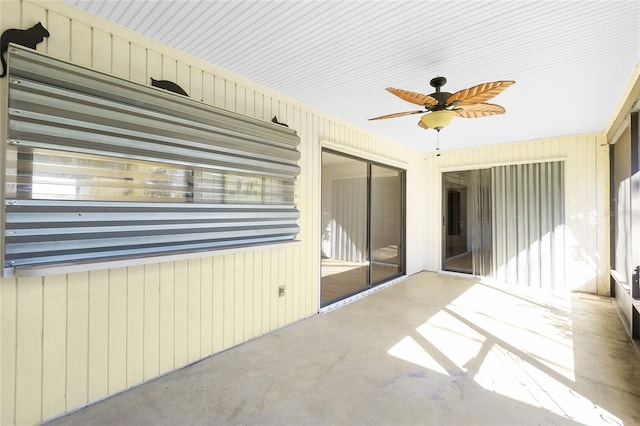 unfurnished sunroom with ceiling fan