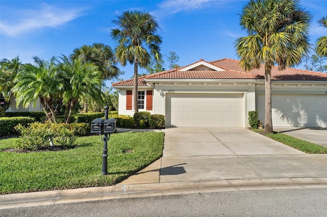 mediterranean / spanish-style house with a front yard and a garage