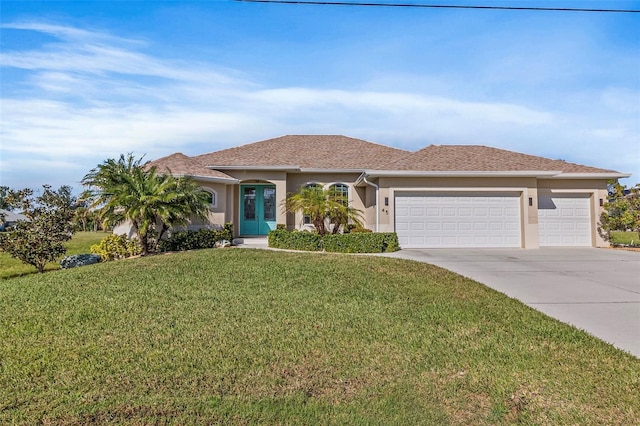 view of front of home featuring a front yard and a garage