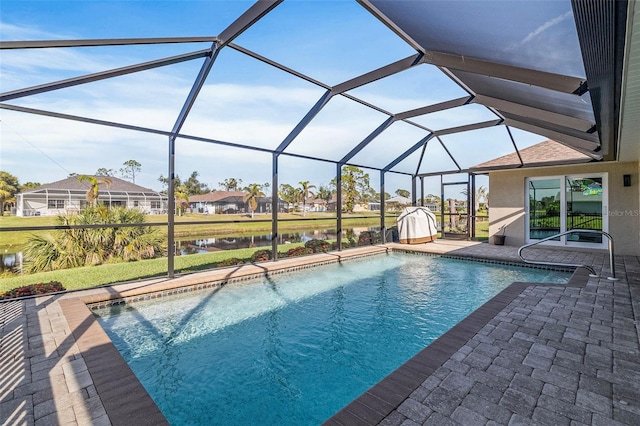 view of swimming pool with a lanai, a water view, and a patio