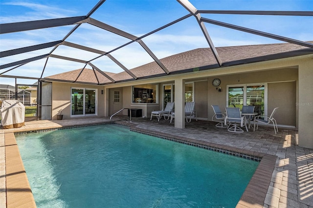 view of swimming pool featuring a lanai and a patio