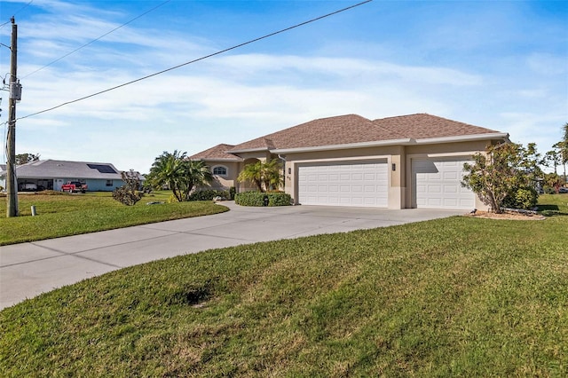 view of front of property featuring a front lawn and a garage