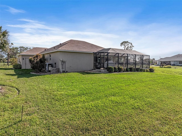 back of property featuring a lawn and a lanai