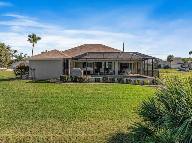 back of house featuring a lanai and a lawn