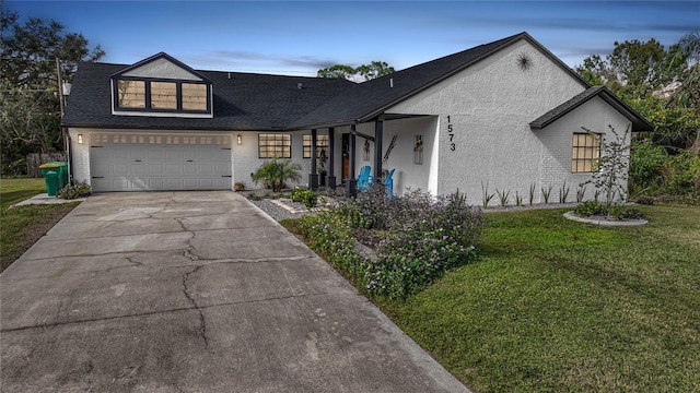 view of front of house with a garage, cooling unit, and a lawn