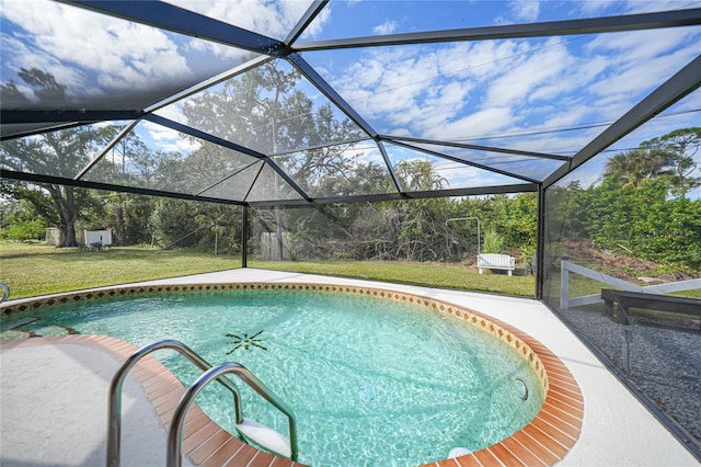 view of swimming pool featuring a lanai and a yard