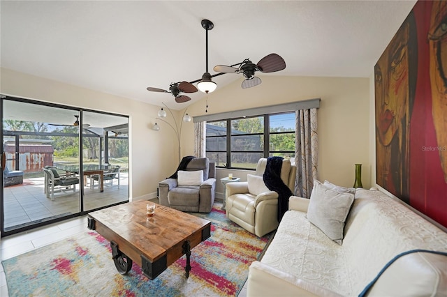 living room featuring vaulted ceiling, ceiling fan, and light tile patterned flooring