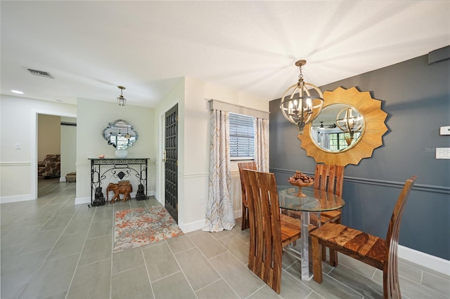 dining space with tile patterned floors and a notable chandelier