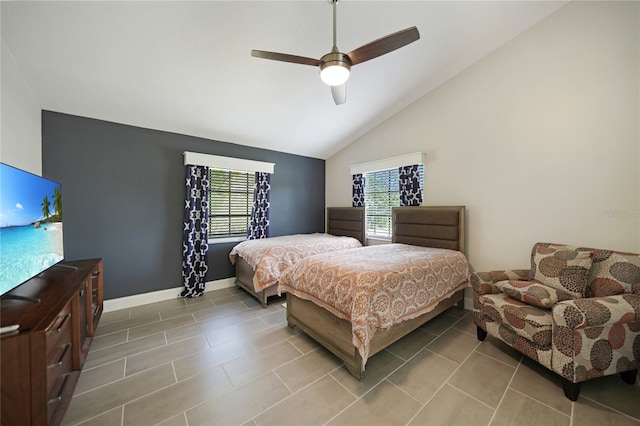 bedroom featuring multiple windows, light tile patterned floors, ceiling fan, and lofted ceiling