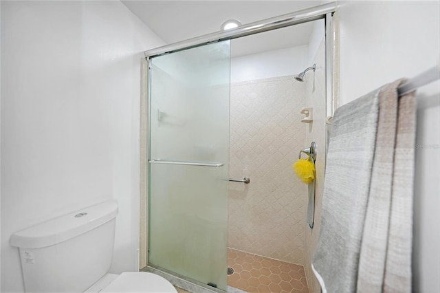 bathroom with an enclosed shower and toilet