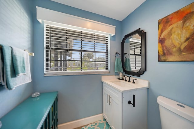 bathroom featuring vanity and toilet