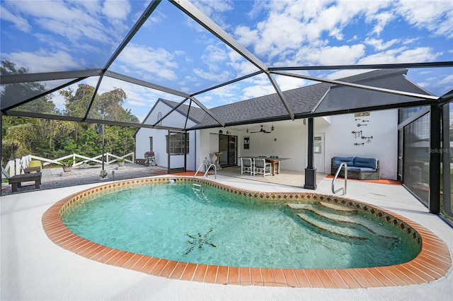 view of pool featuring ceiling fan, a patio area, and glass enclosure