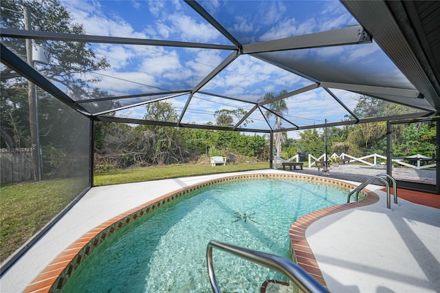 view of swimming pool with a lanai and a patio