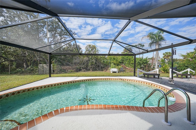 view of pool with glass enclosure and a patio