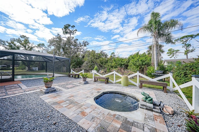 view of patio / terrace with a lanai and a pool with hot tub