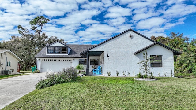 view of front of property featuring central AC unit, a garage, and a front lawn