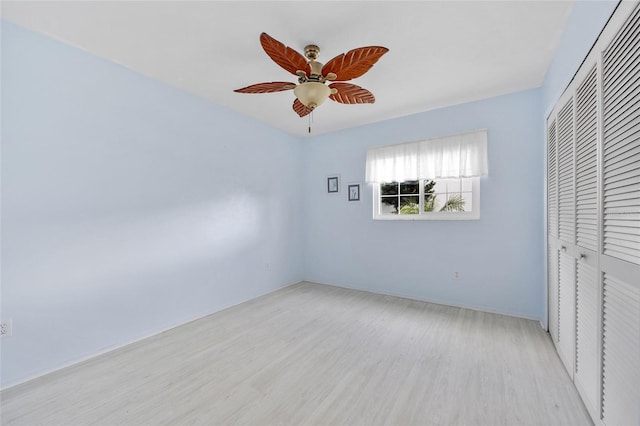 unfurnished bedroom with ceiling fan, a closet, and light hardwood / wood-style flooring