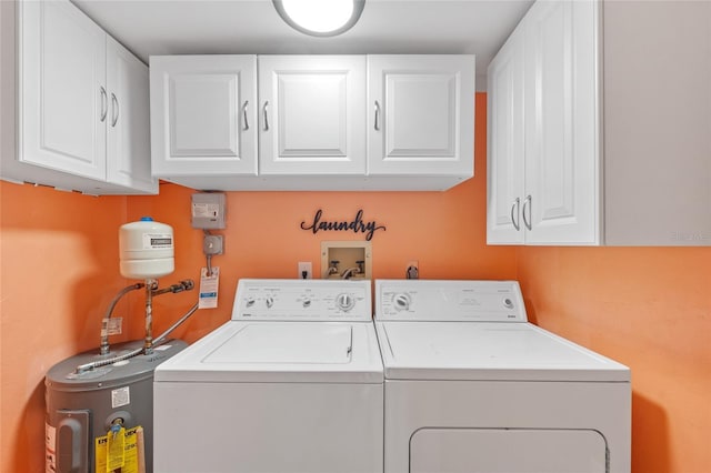 laundry room featuring washer and dryer, cabinets, and electric water heater